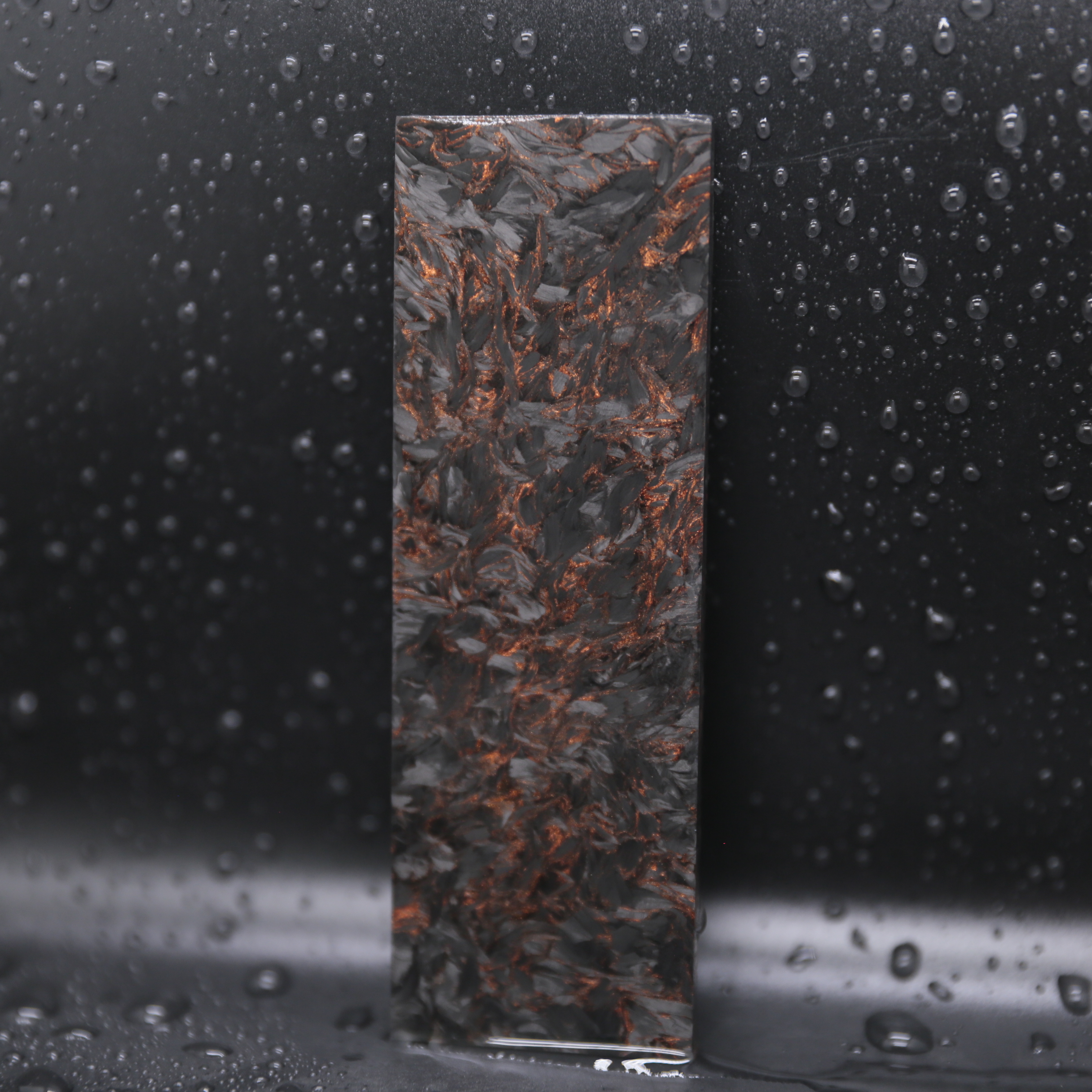 Obsidian Gold Collection forged carbon composite sheet and panel material with black and gold metallic highlights for luxury products.