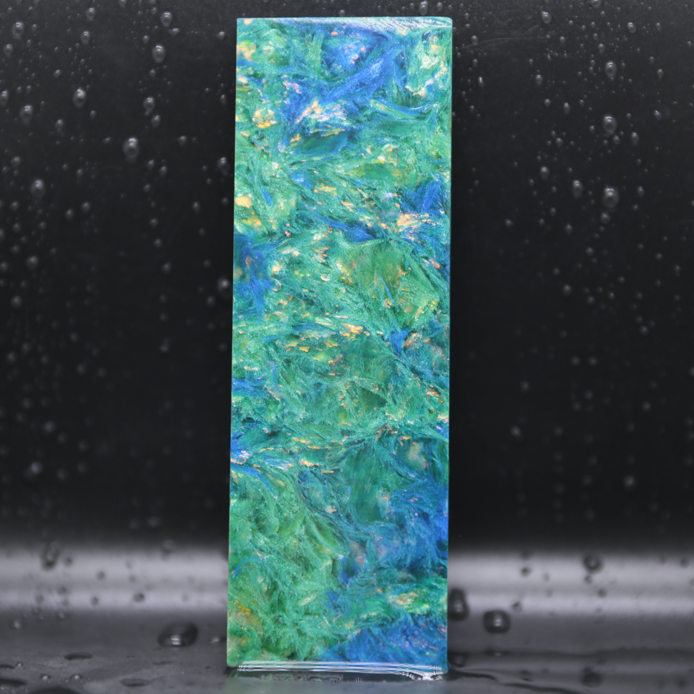 Night Collection forged carbon composite material with hidden blue emerald copper or violet tones for luxury products.